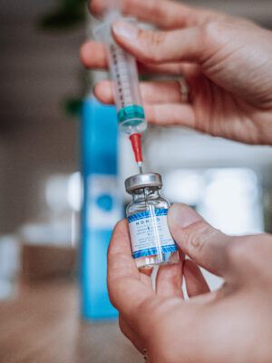 Filling syringe from vaccine vial.
